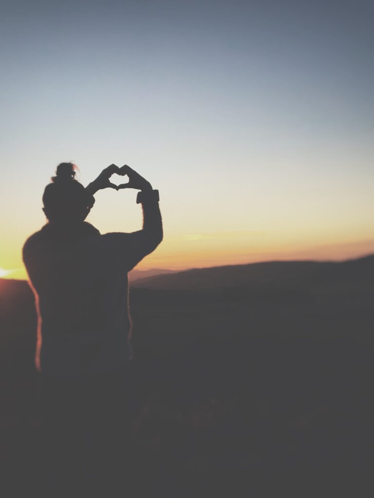 Fulfilled woman holding up Heart