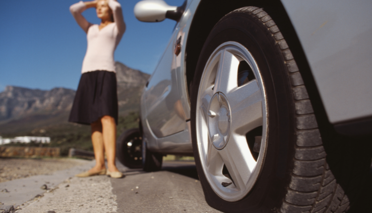 woman with flat tire emergency